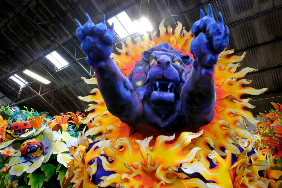 A blue lion bursts through a orange sun