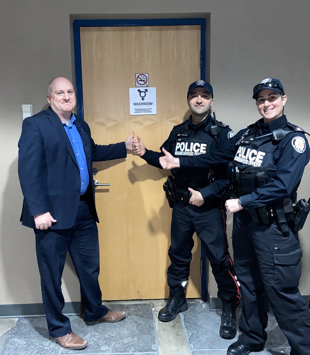 TDotGayCop's tweet photo. The @VillageTownCops &amp; I proudly giving the thumbs up today to our two (yes two!!) new gender neutral washrooms outside of @TPS51Div community room for anyone to use. https://t.co/XVT9Nhs84D