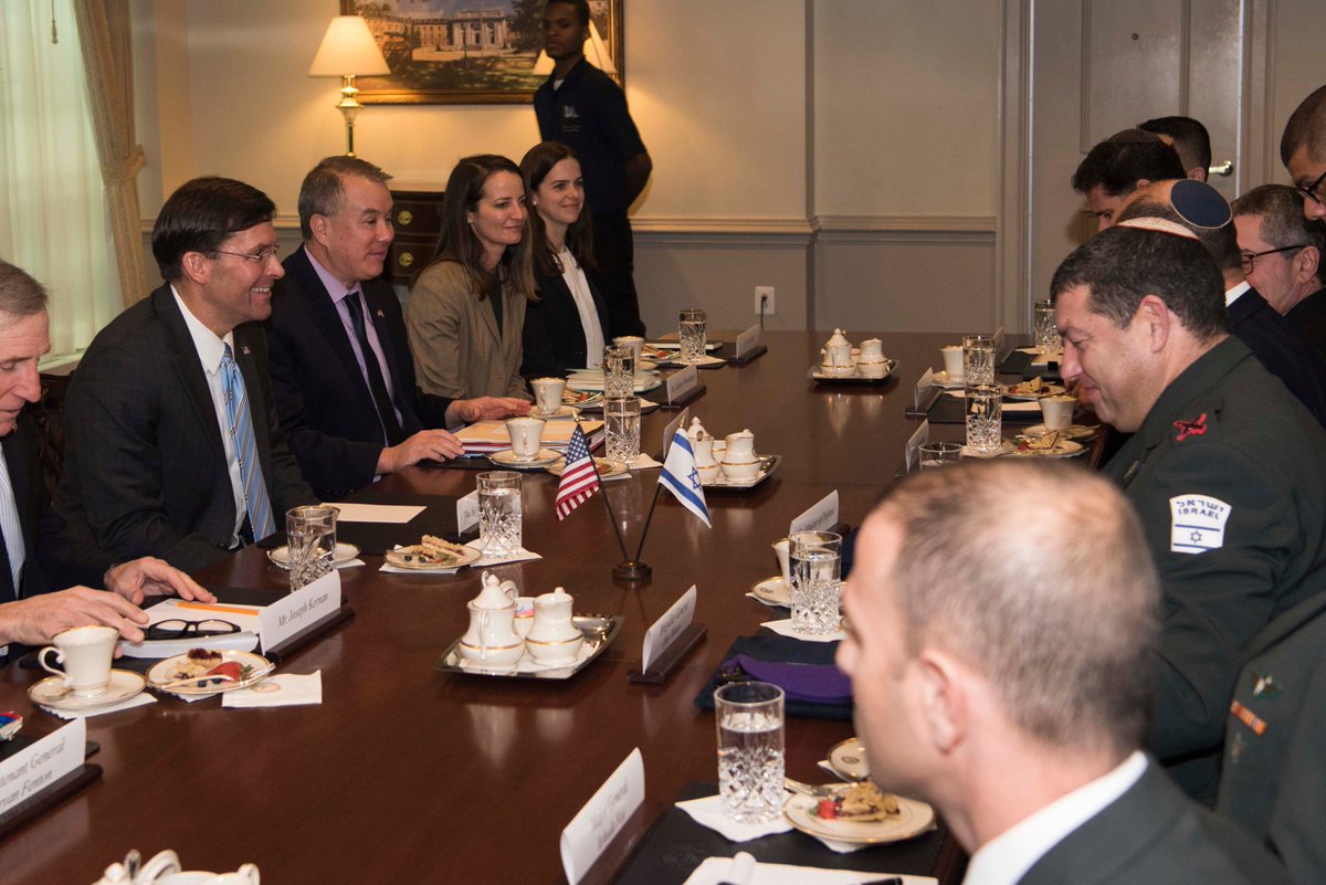 Esper and Bennett are seated with their delegations during the meeting.