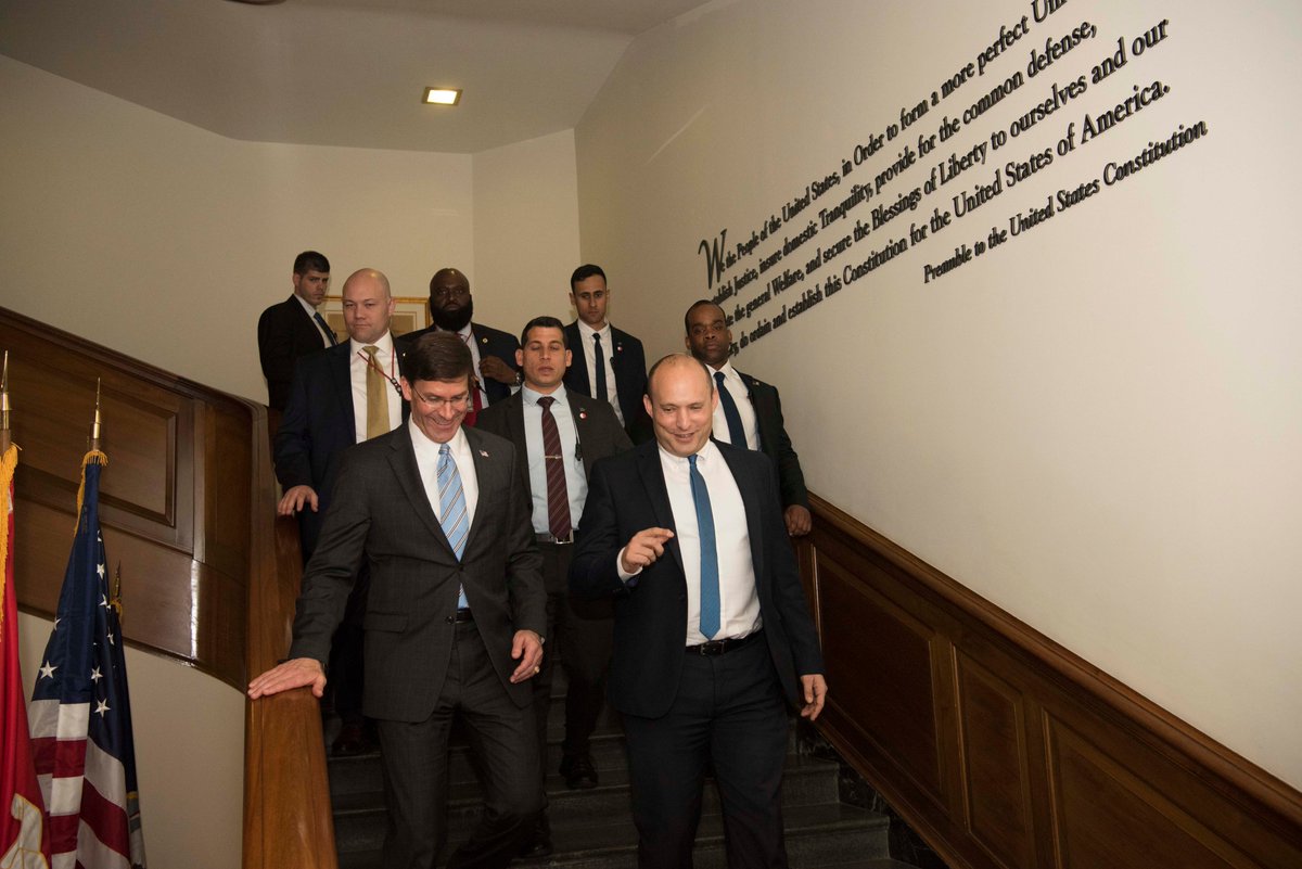 Esper and Bennett walk down a staircase at the Pentagon, as Bennett departs.