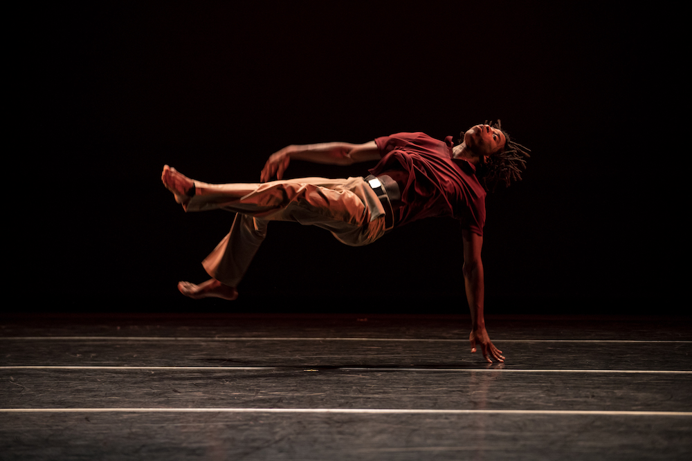 During  a performance Cameron McKinney appears to float on his back mid-air anchored to the stage by only one arm.