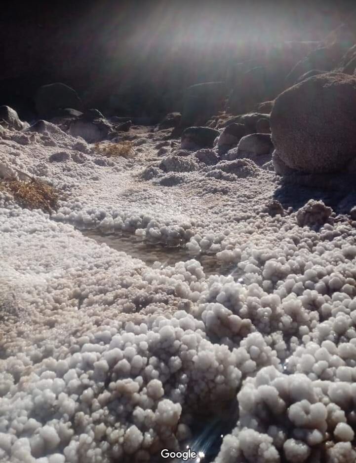 So, after posting the thread, I came across this similar feature about 153km to the NE. https://goo.gl/maps/Co8j5iw295LrgpYT7It’s called Kaf El Melh - and it has outcrop photos!These make it pretty obvious the feature is a salt diapir, and there looks to be basalt blocks in there too!