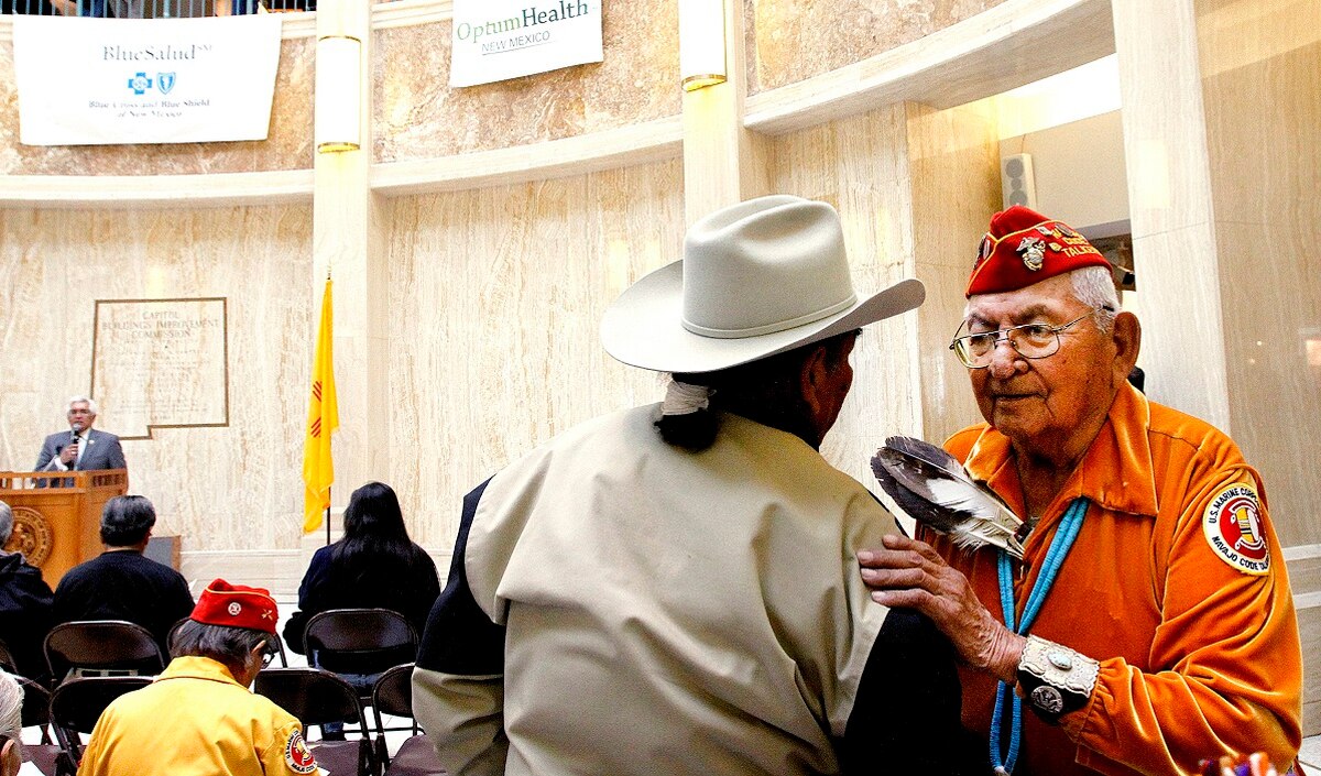 In this Feb. 4, 2011, file photo, Leland Anthony, Arizona Rep. for Indian Health Incorp., left, speaks with Navajo code talker Joe Vandever Sr. during Native American Day at the round house in Santa Fe, New Mexico. (Jane Phillips/The New Mexican via AP) 