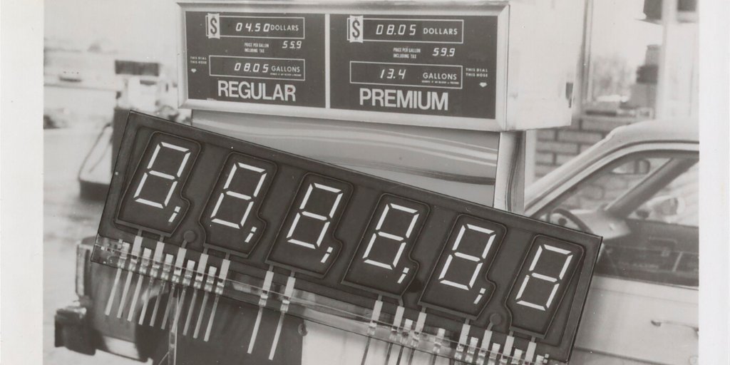 Black and white photo showing an old-fashioned gasoline pump.
