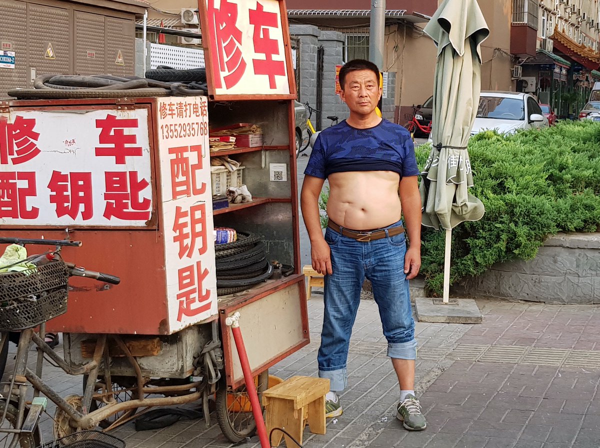 A man with his t-shirt rolled up