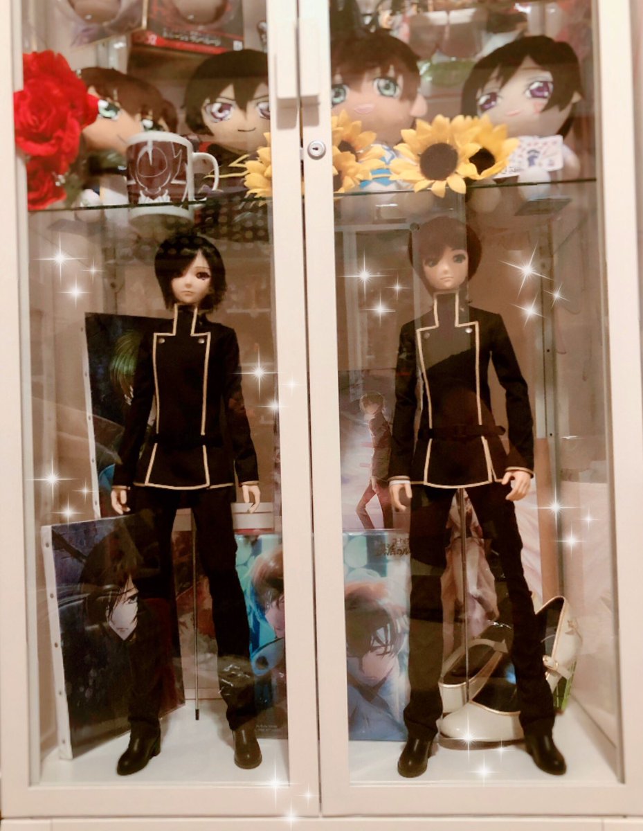 Two smart dolls standing side by side in a glass ikea case