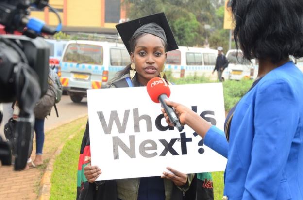 Fireliglntfi's tweet photo. Today morning, graduates from Makerere University positioned themselves along Kampala busy routes with placards asking #WhatsNext? 

Please take a minute to advise these recent graduates.

#NBSUpdates https://t.co/R05cd0YpaT