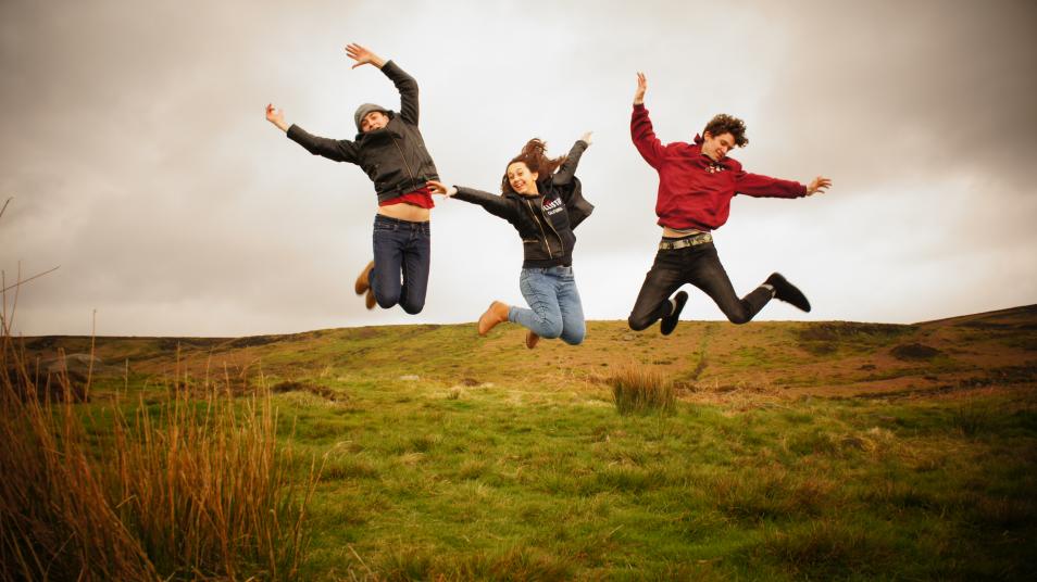 Young people jumping in the country side