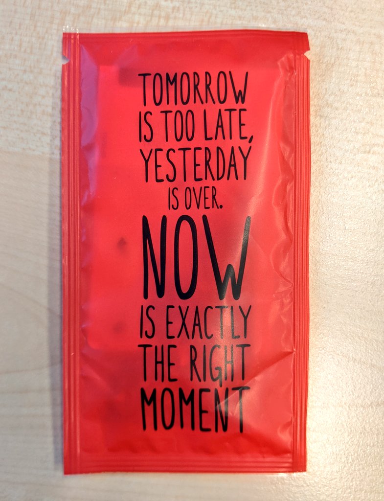 Photo of a red tea packet that reads: " tomorrow is too late, yesterday is over. Now is exactly the right moment"