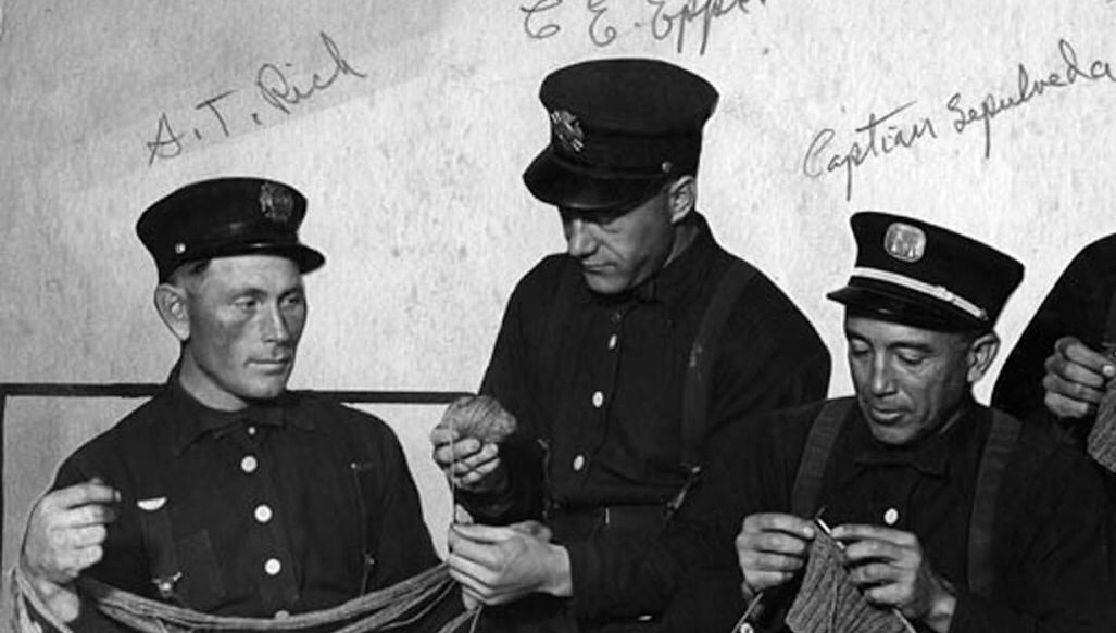 Historical picture of three men knitting