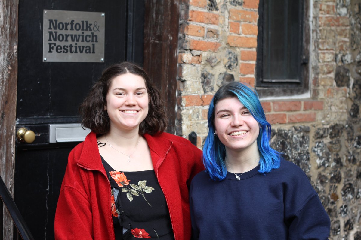A photograph of Georgie and Ellie smiling in front of the NNF offices