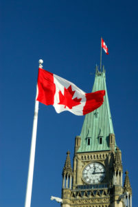Canadian flag in front of parliament building.
