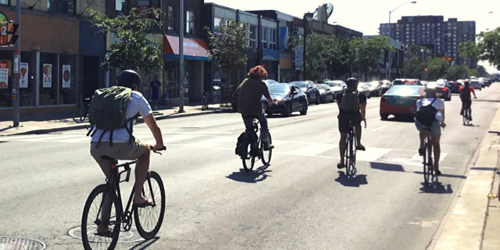 People riding bikes on a city street