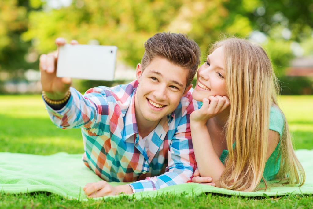 A happy young couple taking a selfie.