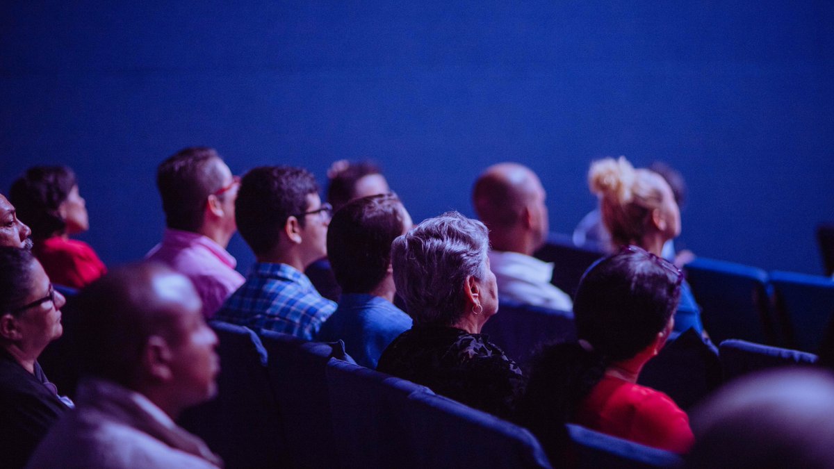 Audience at a professional event listening to a talk.
