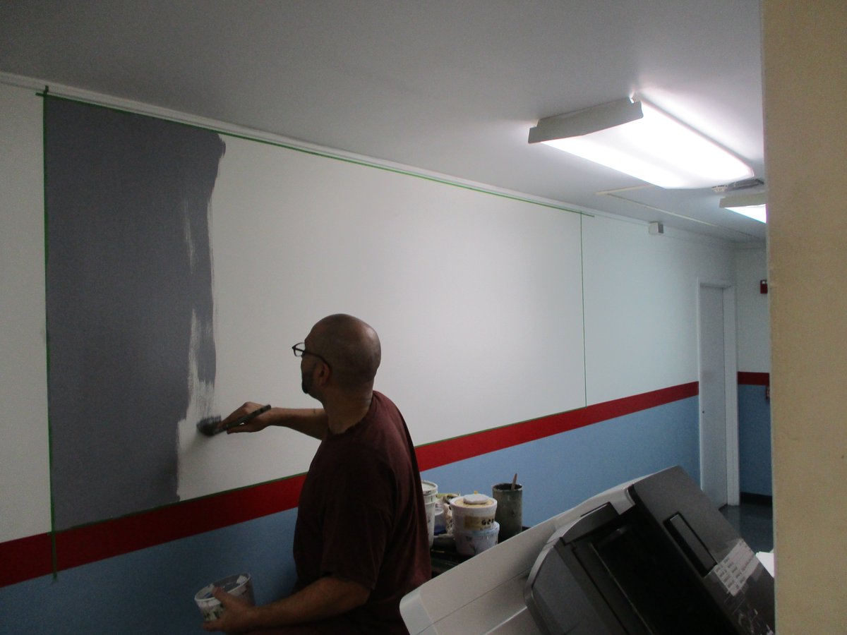 An inmate paints a mural at SCI Waymart