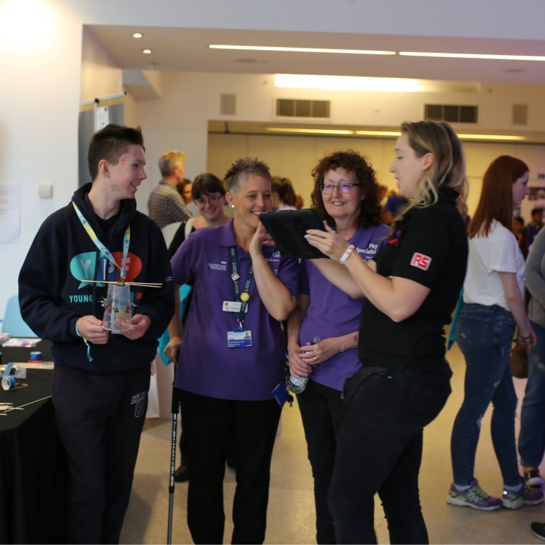 Members of the Play team talking to a young person and a careers representative at the GOSH Teens Careers Festival.