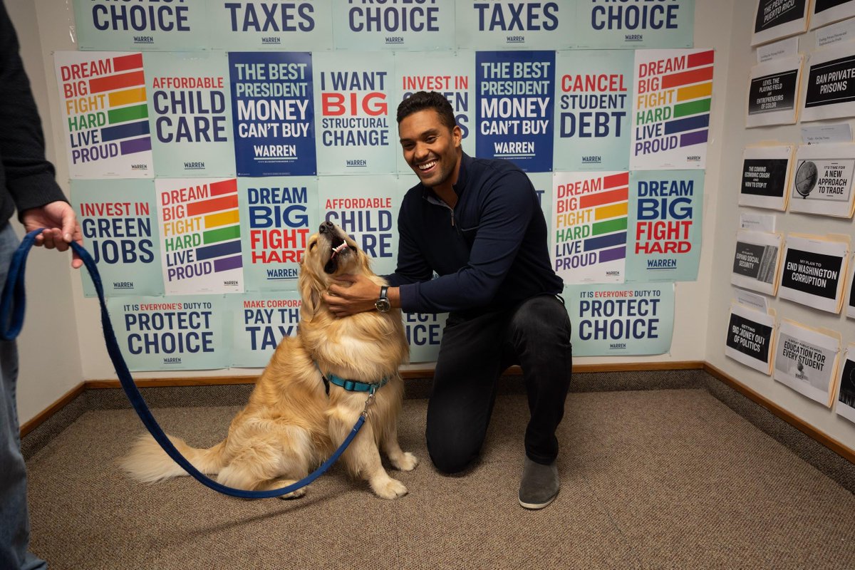 A supporter poses for a selfie with Elizabeth's dog, Bailey.