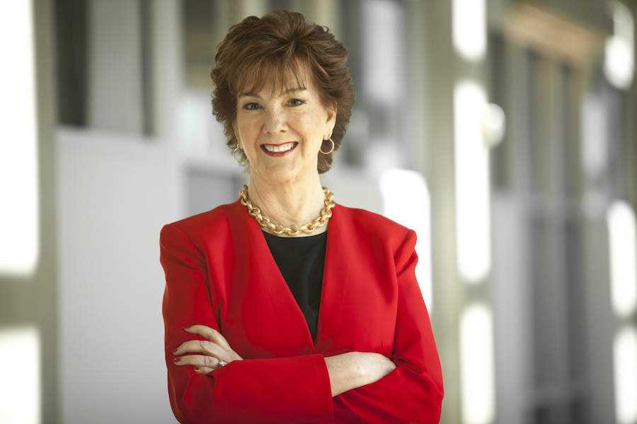 Photo of Mary Anne Alhadeff standing with her arms folded 