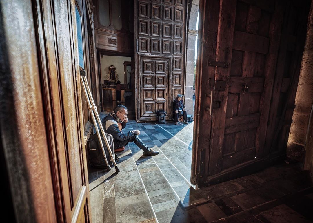 Two men at entrance of Catholic temple in Coyoacán, Mexico City.