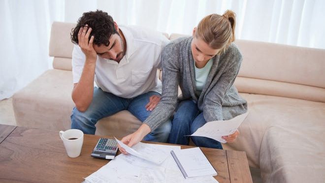 a couple looking over bills