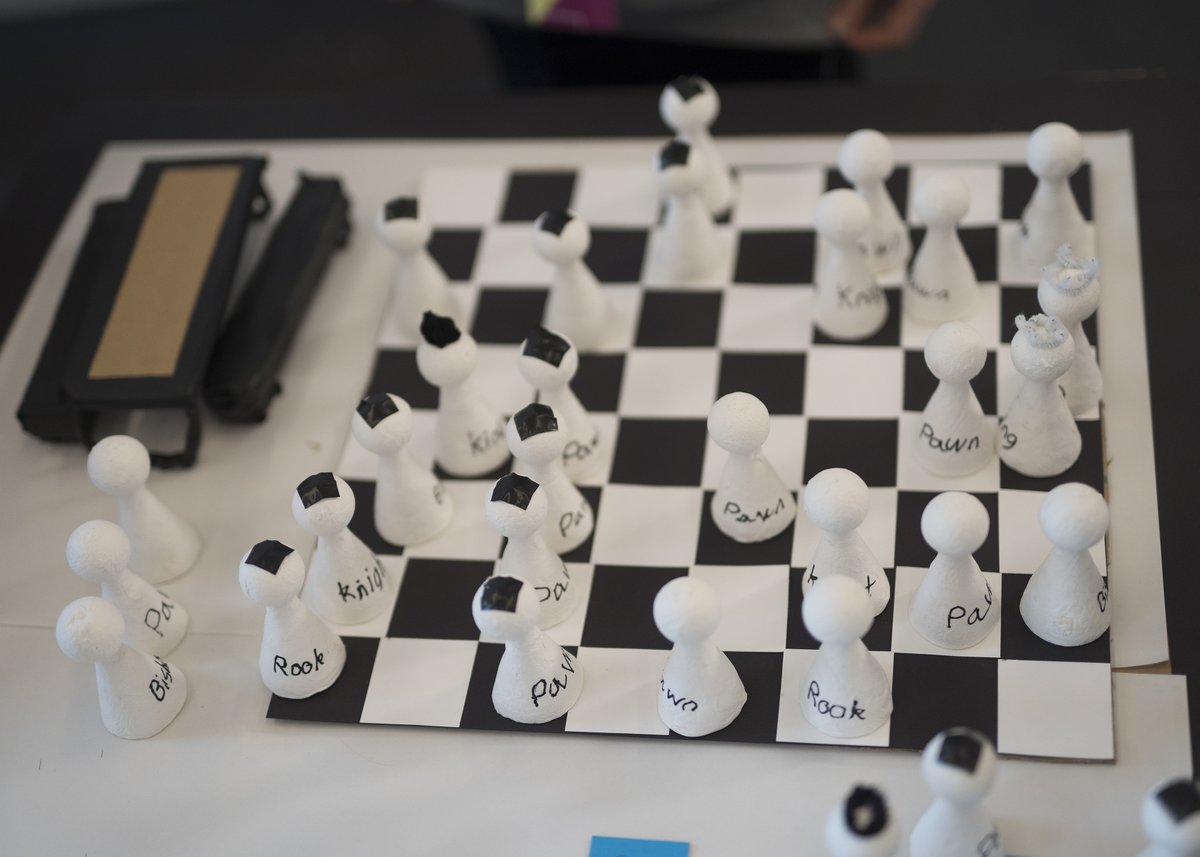Prototype of a chess board created to help combat loneliness and isolation. Made from paper, plastacine and chess figures.