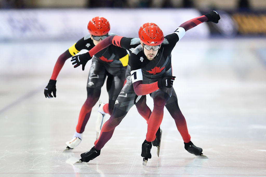 three Team Canada athletes compete during the Men's Team Pursuit in speed skating