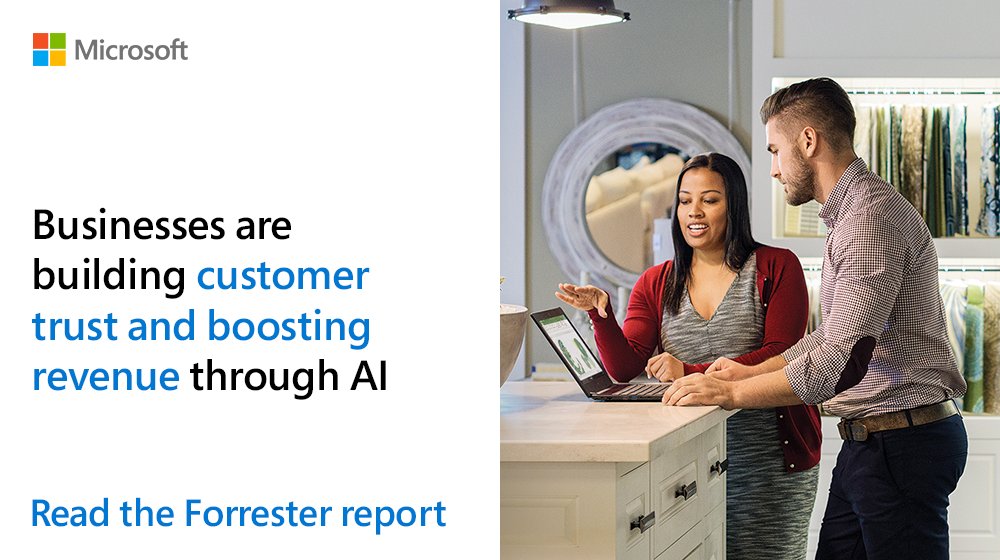 Guy and girl having a conversation while standing next to an open laptop.