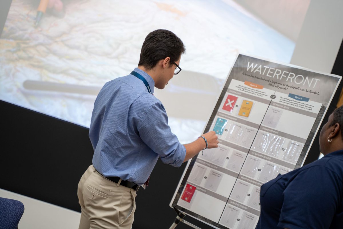One teen working on a poster board