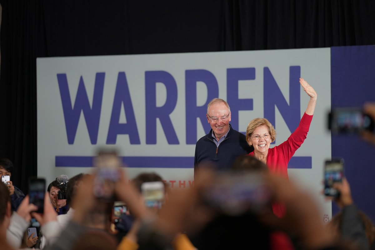 Elizabeth Warren and her husband Bruce wave to a crowd of supporters.