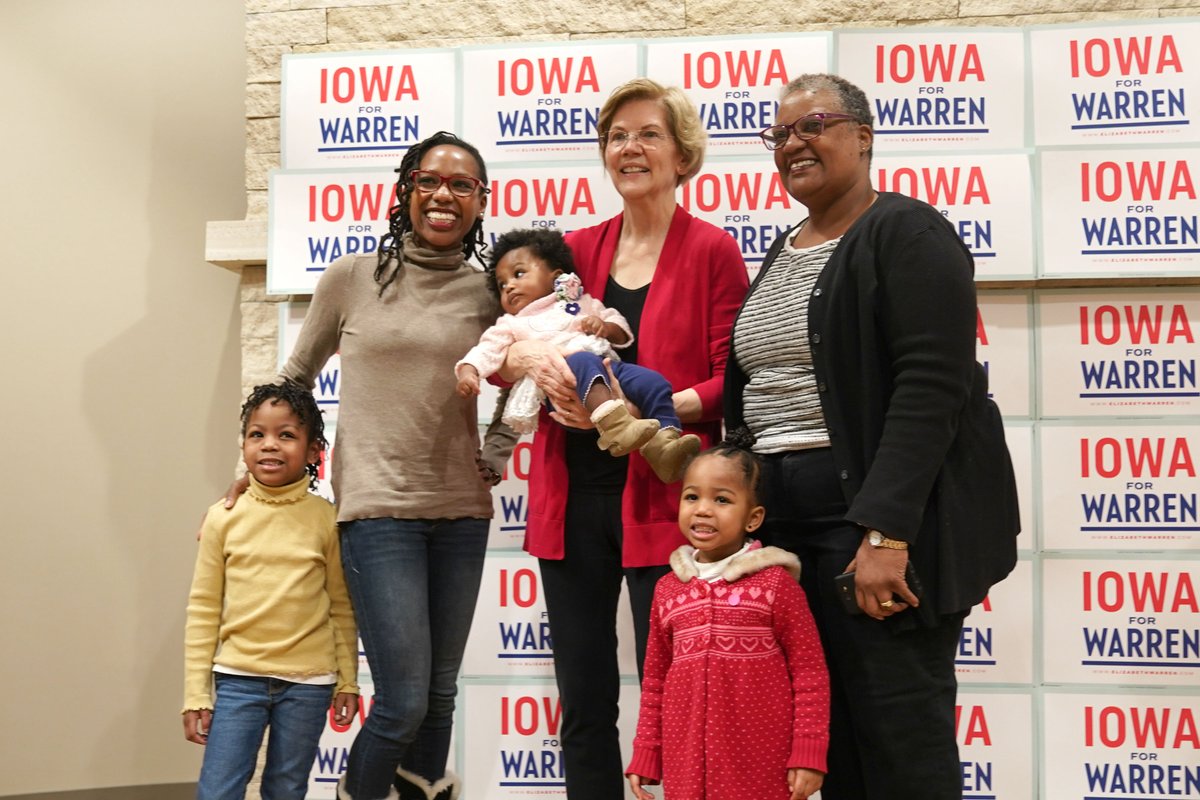 Elizabeth Warren takes a photo with a family of supporters.