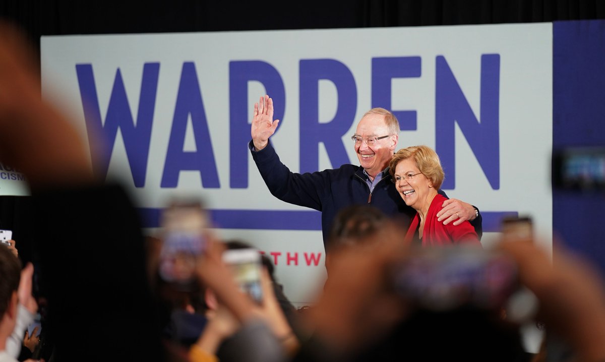 Elizabeth Warren and her husband Bruce wave to a crowd of supporters.