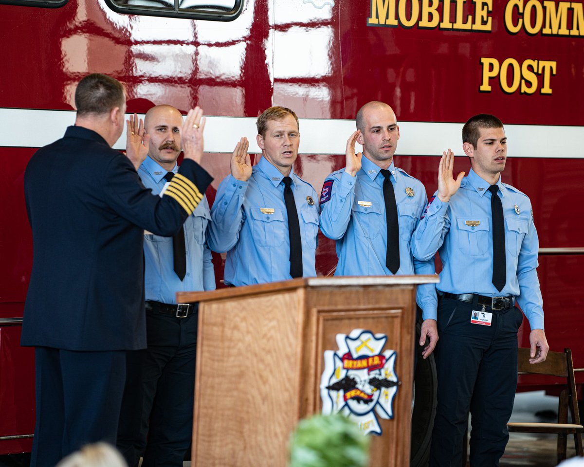Four men being sworn in as firefighters