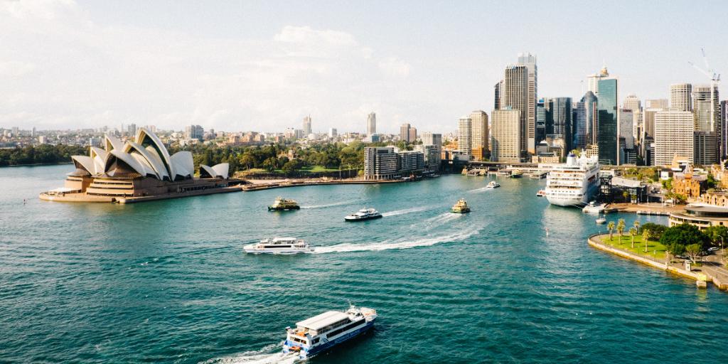 Boats in a city harbor in Sydney Australia