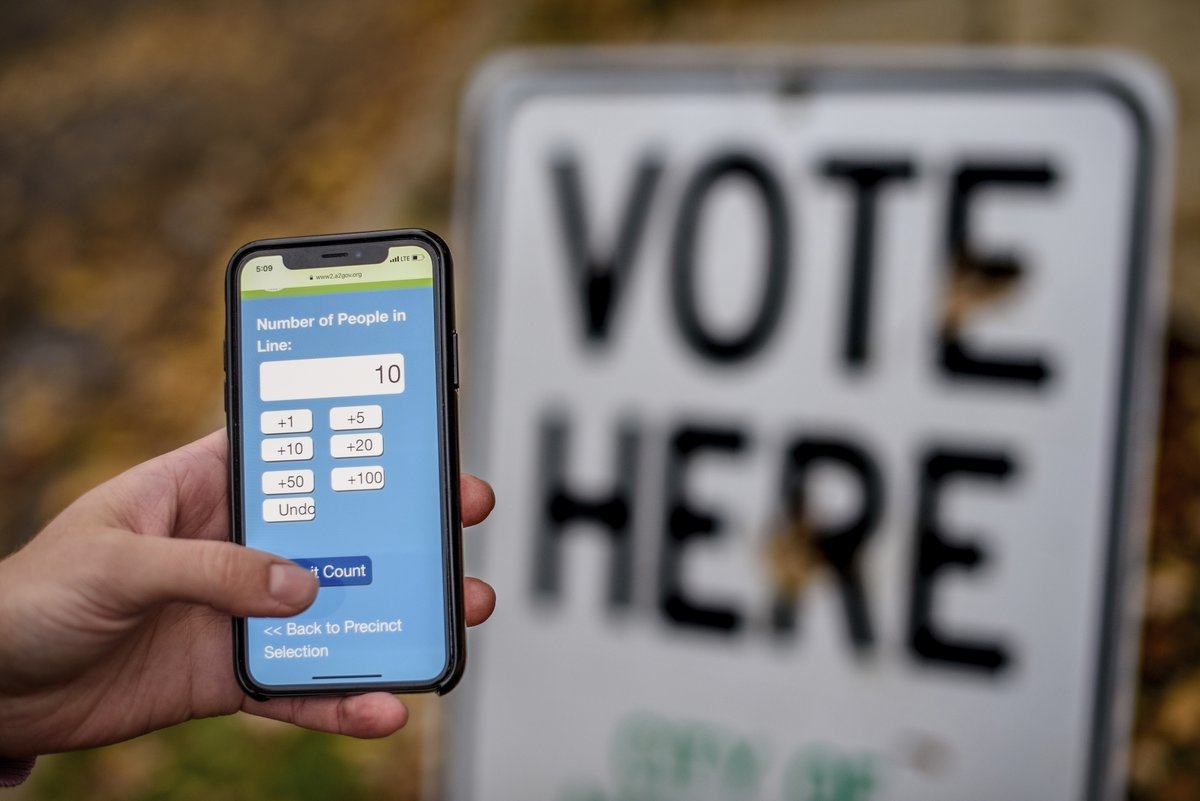 phone with Vote Here sign