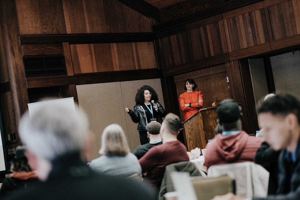 Members of Netlify's People Team speak from the stage to a room full of colleagues