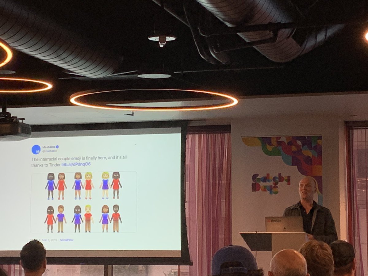 Kyle Boss onstage with slide showing tweet from Mashable: The interracial couple emoji is finally here, and it’s all thanks to Tinder.