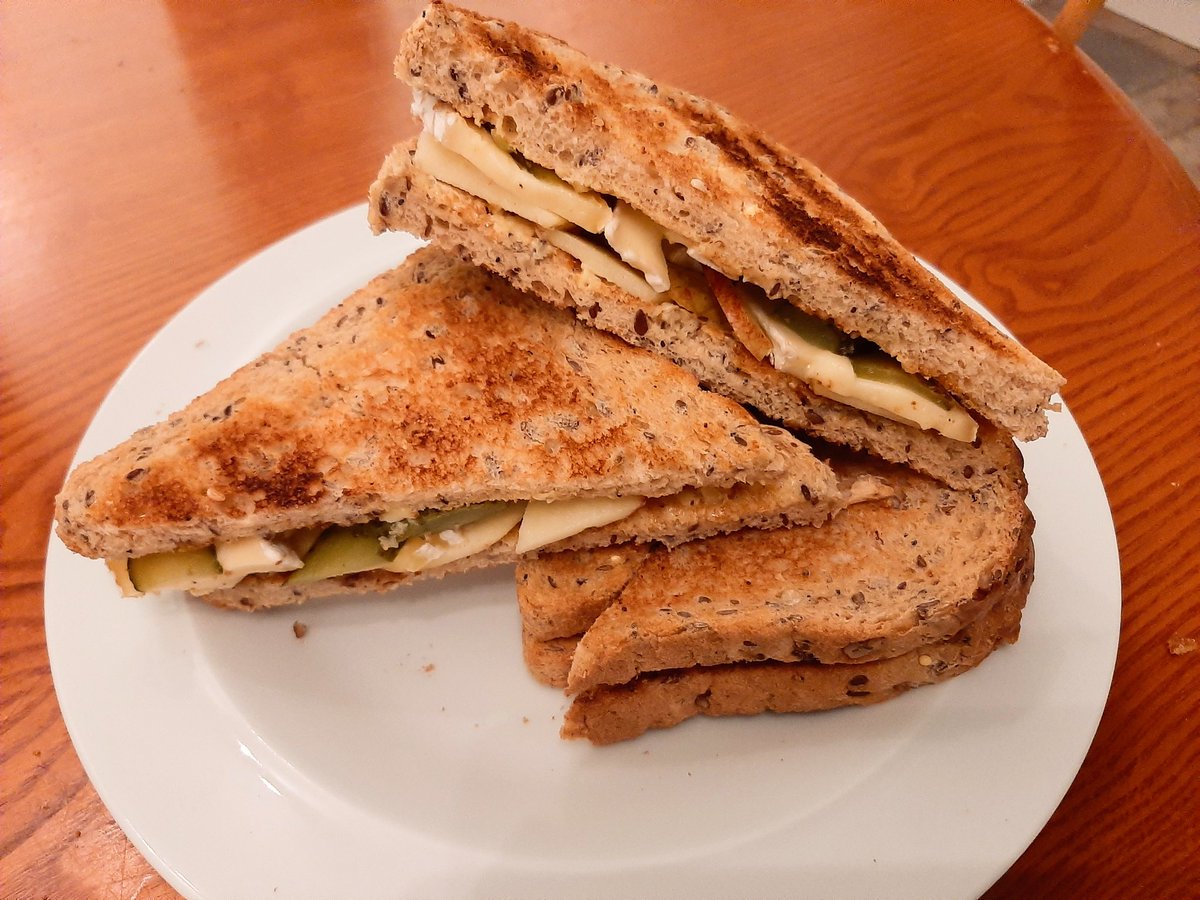 A plate of sandwiches. The bread is toasted.