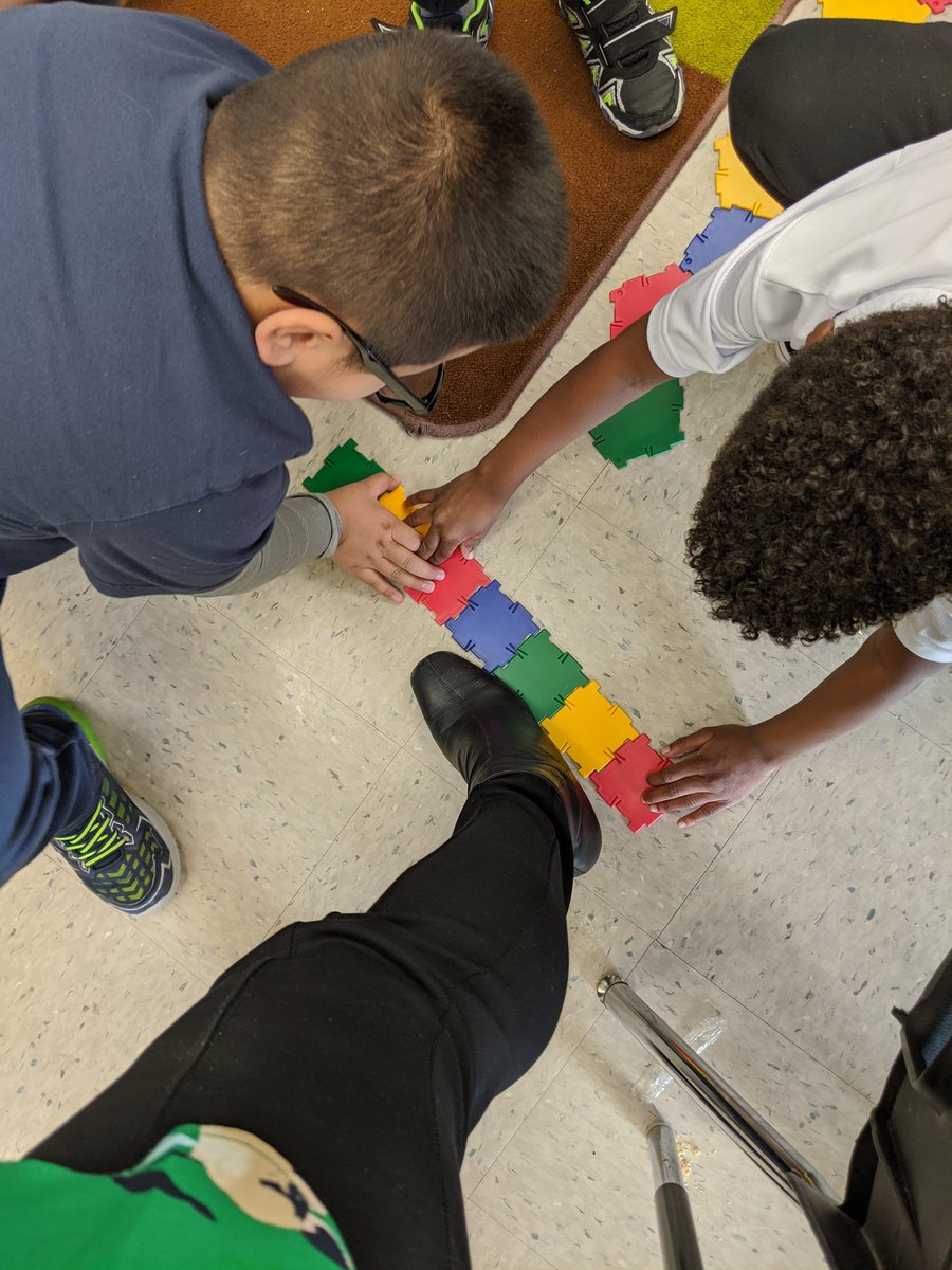 NGMBowen's tweet photo. When you stand still for a few minutes and find yourself being measured 🤣. Feet measured in non-standard units by Gr. 1s @stahces Do shoes come in a "Size 4 Squares"? #polydrons @hwcdsbmathk8 #cutiepies #handsonmath https://t.co/xuZcKpwNOC