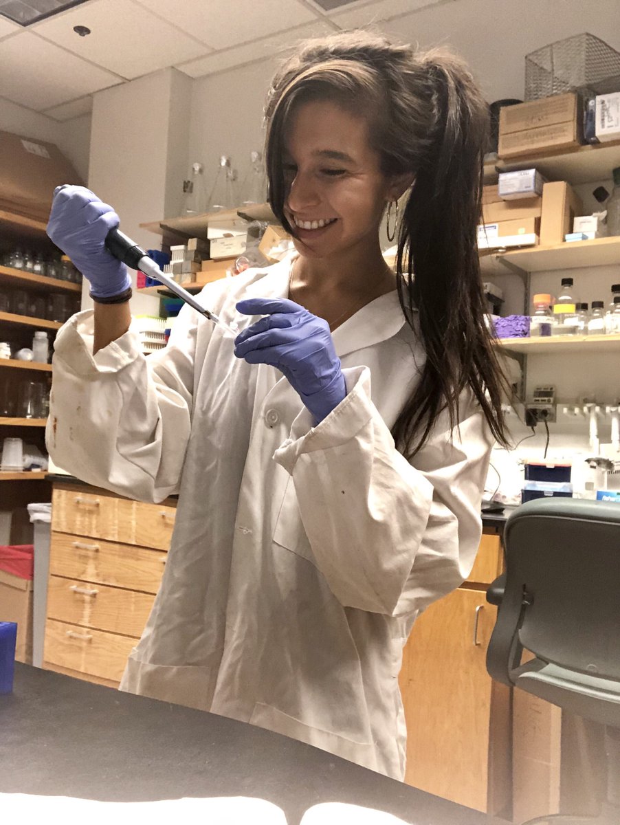 Tori in a lab coat, holding a pipette.