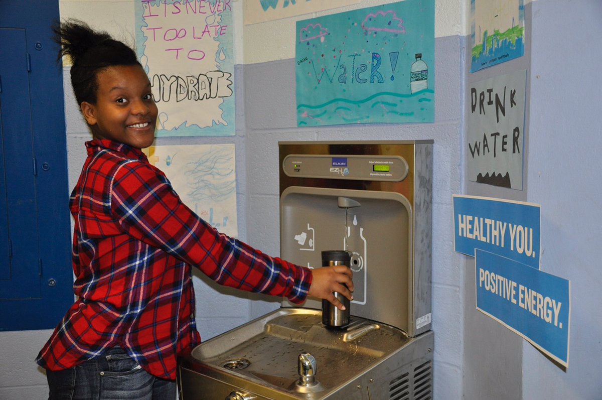 a student posing with a hydration station