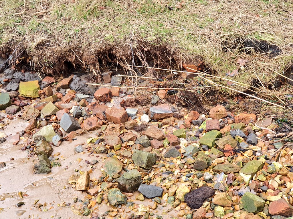 Brickwork eroding along the shoreline
