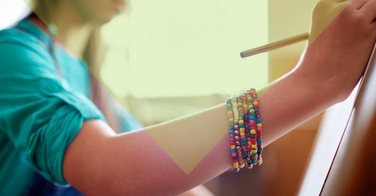 female teen painting on an easel