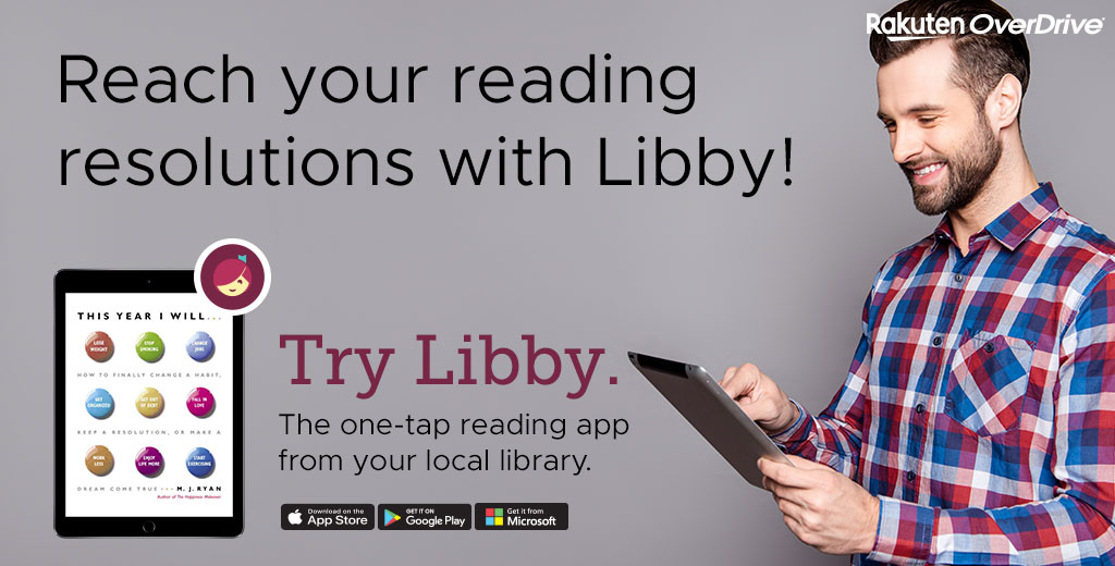 a man smiling holding a tablet looking down