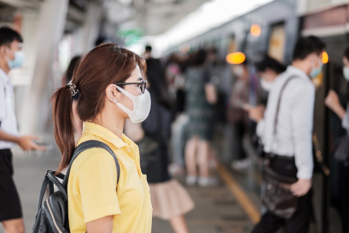 Young Asian woman wearing protection mask against the coronavirus (2019-nCoV) at public train station