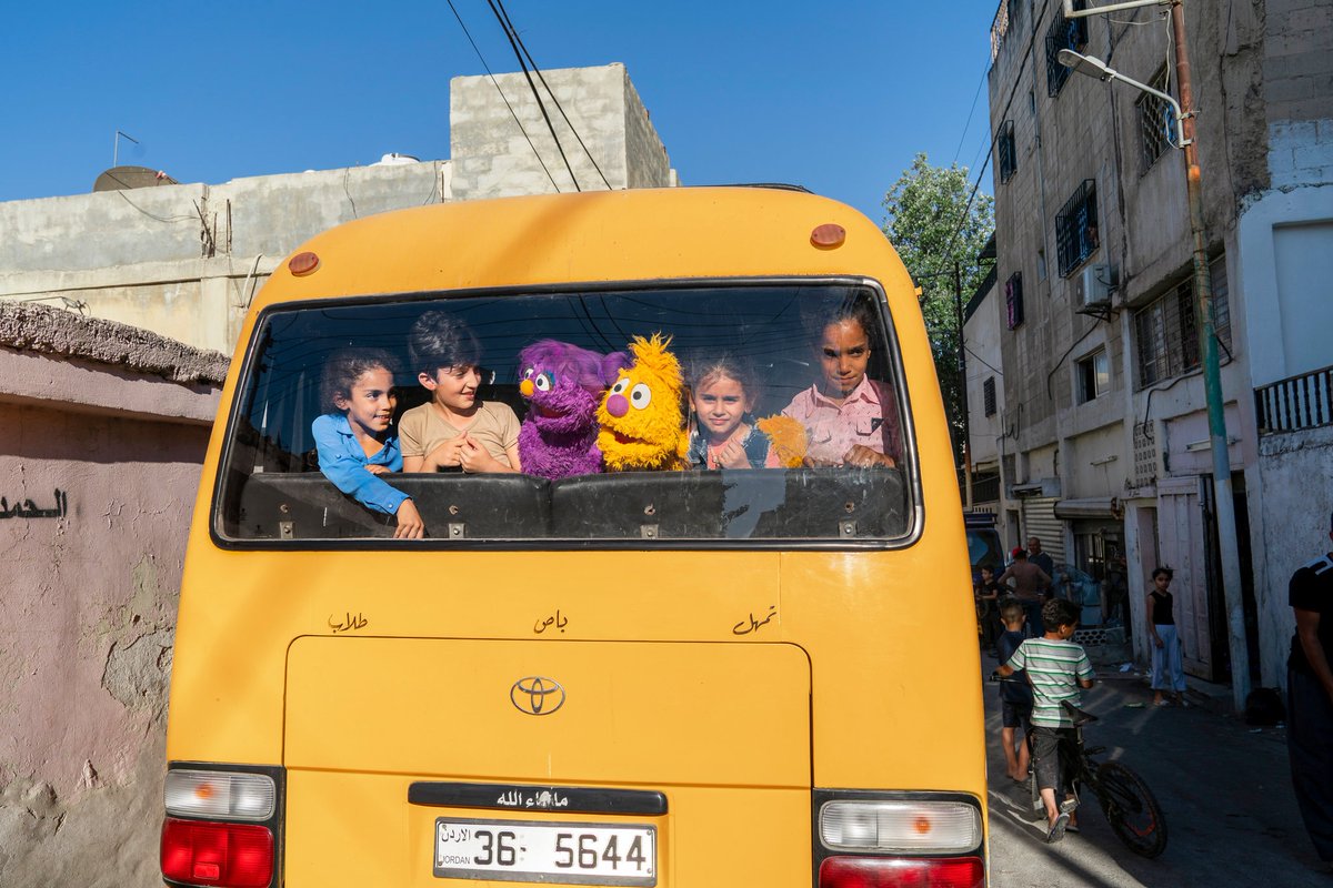kids and muppets on bus