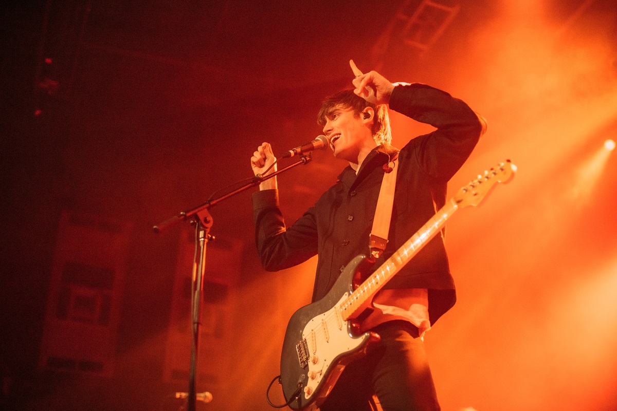 Jake Luppen sings into microphone