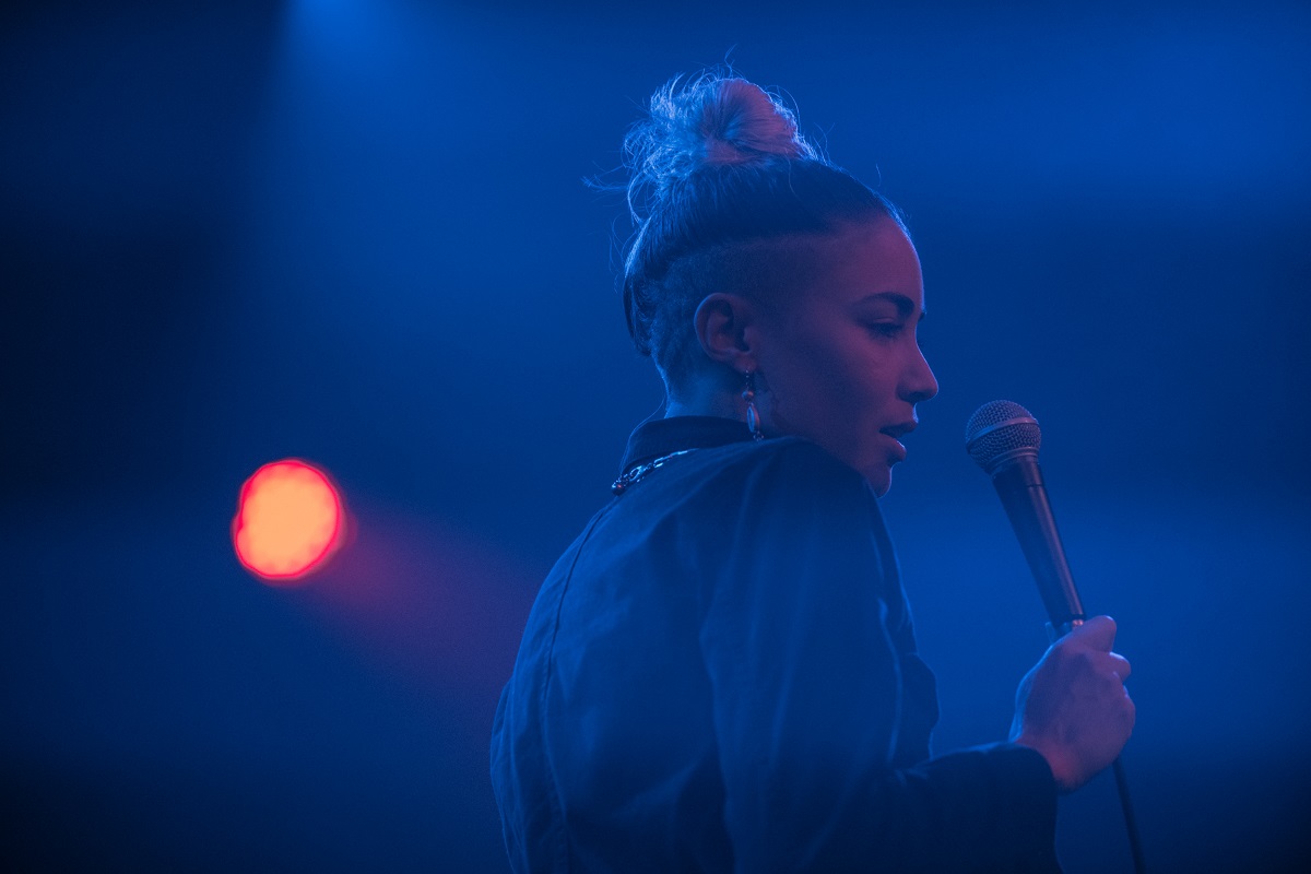 Ness Nite holds microphone