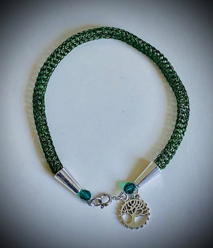 Green wire knit bracelet with tree charm