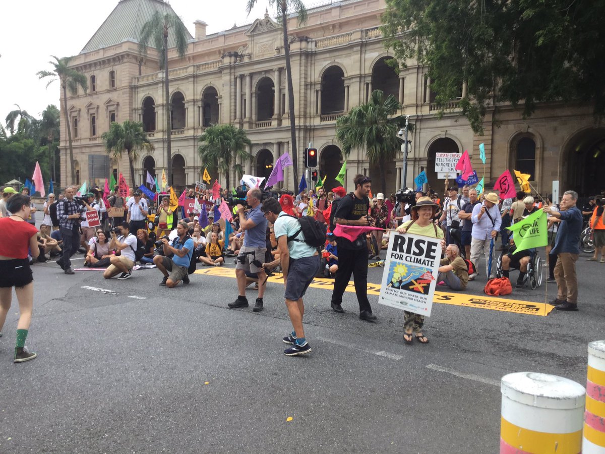 A crowd on the street, blocking an intersection.